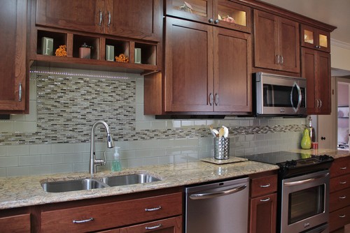 Glossy Gray Ceramic Subway Tiles and Gray Tones Glass Matchstick Inlay with American Walnut Stained Cherry Cabinets with Cambria Buckingham Countertop